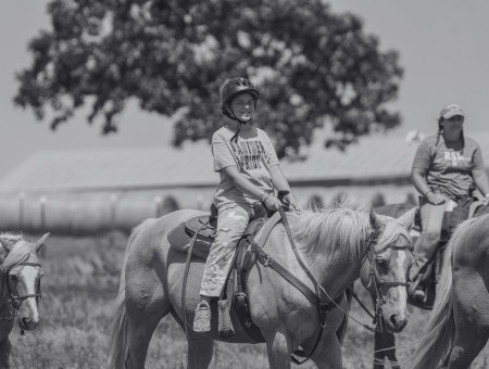 Campers riding horses